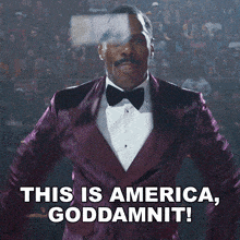 a man in a purple tuxedo and bow tie says this is america goddamnit