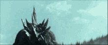 a black and white photo of a monster with spikes on it