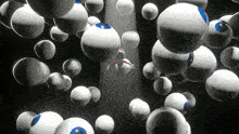 a computer generated image of a person surrounded by balls with blue eyes