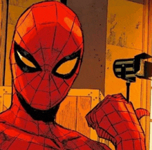 a close up of a spiderman holding a microphone in his hand .