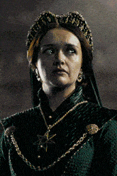 a woman in a green dress has a star necklace
