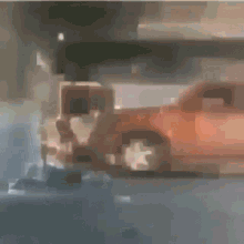 a blurry picture of a white truck and an orange car