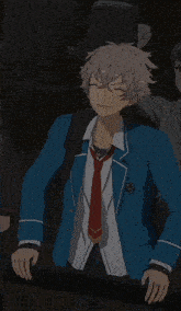 a man in a blue suit and red tie is pointing