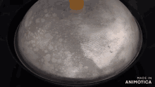 a pan with a lid that says made in animotica on the bottom