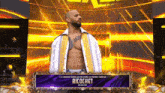 a wrestler named ricochet is on a stage