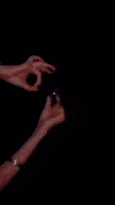 a picture of a person holding a sparkler with arabic writing behind them