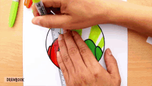 a person is using a ruler to draw a heart on a piece of paper ..