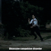a man is walking down a street with the words obsessive compulsive disorder written below him