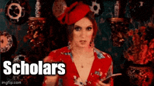 a woman in a red dress and red hat is holding a cell phone in front of vases and plates .