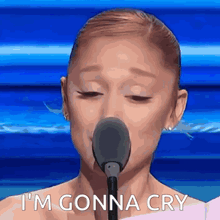 a woman is crying in front of a microphone and says i 'm gonna cry .