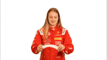 a woman wearing a red racing suit with the word iron dames on it
