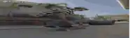 a man in a striped shirt is riding a skateboard down a street ..