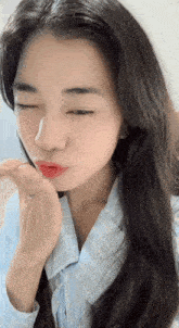 a close up of a woman making a funny face with her eyes closed