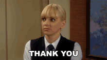 a woman says thank you in front of a picture