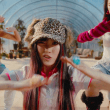 a girl wearing a leopard print hat and ear muffs