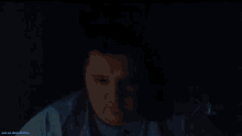 a screen shot of a person 's face with a blue light coming out of their mouth