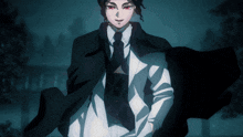 a man in a suit and tie is walking in the dark