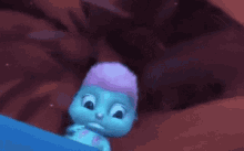 a blue cartoon character with a purple haircut is standing on a rock .
