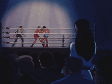 a group of people are watching a boxing match