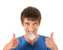 a young man is holding a condom in his mouth and giving two thumbs up