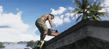 a man is working on the roof of a building near the water