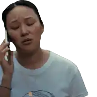a woman in a white shirt is talking on her cell phone