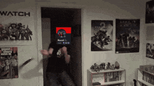 a man is standing in front of a wall with a halo 2 poster on it
