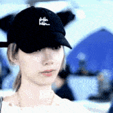 a woman wearing a black hat that says shh