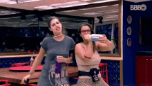 two women are posing for a picture and one has a shirt that says i 'm the boss