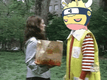 a woman holding a bag of mcdonald 's french fries next to a cartoon character