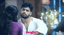 a man with a beard is talking to a woman and the word really is on the bottom