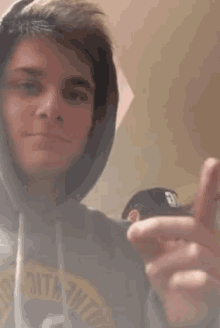 a man wearing a hoodie that says ' 3tm tht ' on it
