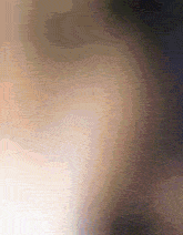 a blurred image of a person 's face and neck