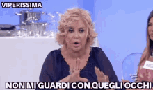 a woman with a surprised look on her face says viperissima non mi guardi con quegli occhi .