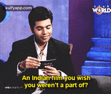 a man in a suit is talking about an indian film he wished he weren 't a part of