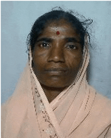 a woman with a red dot on her forehead is wearing a pink scarf and looking at the camera .