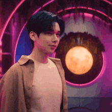 a man standing in front of a full moon in a room