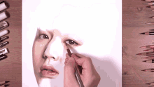 a person is drawing a woman 's face with a brown pencil