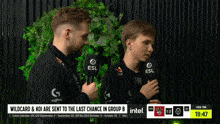 two men with microphones in front of a sign that says intel