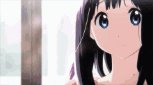 a girl with long black hair and blue eyes looks at the camera .