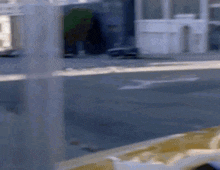 a blurry picture of a car driving down a city street .