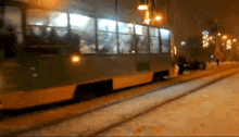a blurred image of a bus going down a snowy street