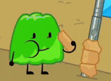 a green cartoon character is holding a piece of wood in his mouth .
