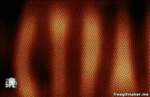 a blue ball is floating in the air on a red and yellow curtain .