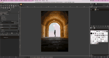 a computer screen shows a picture of a man standing in front of a brick archway