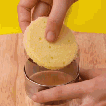 chocolate is being poured into a container on a cutting board
