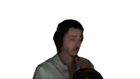 a man wearing headphones looks at the camera with a white background