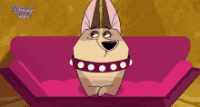 a cartoon dog is sitting on a pink couch with disney premiere written on the bottom right