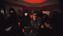 a man wearing a mask is holding a gun and a gun that says ' assault rifle ' on the back