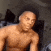 a shirtless man is making a funny face in a living room .